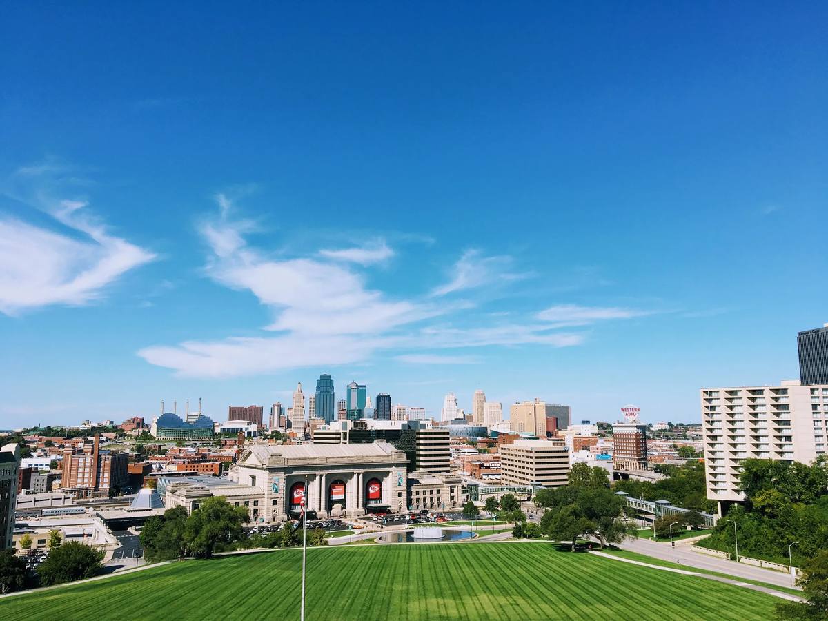 Kansas City skyline and Union Station seen from the Liberty Memorial lawn under a blue sky